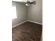 Bright bedroom with ceiling fan and wood-look floors at 4600 Millstone Dr # D, Raleigh, NC 27604