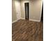 Spacious bedroom with wood-look floors and ample closet space at 4600 Millstone Dr # D, Raleigh, NC 27604