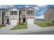 Tan two-story townhome with attached garage and landscaping at 510 Fife Ct, Gibsonville, NC 27249