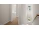 Upstairs hallway with carpet, leading to bedrooms and natural light at 510 Fife Ct, Gibsonville, NC 27249