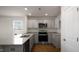 Modern kitchen with granite countertops and stainless steel appliances at 510 Fife Ct, Gibsonville, NC 27249