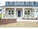 Front porch with blue door and stone accents at 590 Glenkirk Pl, Garner, NC 27529