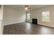 Living room with hardwood floors, fireplace, and large windows at 590 Glenkirk Pl, Garner, NC 27529