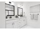 Modern bathroom with double vanity and large mirrors at 700 Portia Way, Homesite 17, Morrisville, NC 27560