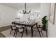 Modern dining area with kitchen views and chandelier at 700 Portia Way, Homesite 17, Morrisville, NC 27560