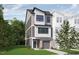 Modern 3-story townhome with gray siding, brick accents, and a 2-car garage at 700 Portia Way, Homesite 17, Morrisville, NC 27560