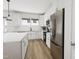 Modern kitchen with white cabinets, stainless steel appliances and island at 700 Portia Way, Homesite 17, Morrisville, NC 27560