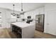 Modern kitchen with white cabinets, large island, and stainless steel appliances at 700 Portia Way, Homesite 17, Morrisville, NC 27560