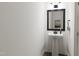 Stylish powder room with pedestal sink and framed mirror at 700 Portia Way, Homesite 17, Morrisville, NC 27560