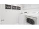 Laundry room with washer, dryer and overhead shelving at 702 Portia Way, Homesite 16, Morrisville, NC 27560