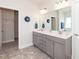 Double vanity bathroom with modern cabinets and large mirror at 104 Newport Landing Lndg # 100, Garner, NC 27529