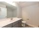 Gray vanity, toilet, and shower in this simple bathroom at 104 Newport Landing Lndg # 100, Garner, NC 27529