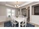 Formal dining room with white table, chairs, and a decorative chandelier at 104 Newport Landing Lndg # 100, Garner, NC 27529
