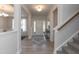 Light-filled entryway with hardwood floors, stairs, and a small console table at 104 Newport Landing Lndg # 100, Garner, NC 27529