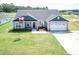 Gray two-story house with a two-car garage and manicured lawn at 104 Newport Landing Lndg # 100, Garner, NC 27529