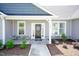Two-story home exterior with gray siding, stone accents, and a covered front porch at 104 Newport Landing Lndg # 100, Garner, NC 27529