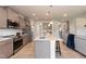 Modern kitchen with gray cabinets, granite countertops, stainless steel appliances, and an island at 104 Newport Landing Lndg # 100, Garner, NC 27529