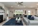 Living room featuring gray sofas, a fireplace, and a large window with backyard view at 104 Newport Landing Lndg # 100, Garner, NC 27529