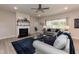 Spacious living room with gray sofas, a fireplace, and large windows at 104 Newport Landing Lndg # 100, Garner, NC 27529
