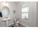 Clean powder room with pedestal sink and large window at 104 Newport Landing Lndg # 100, Garner, NC 27529
