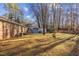 Side yard view of house with shed and wooded area at 112 Collums Rd, Chapel Hill, NC 27514