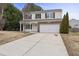 Two-story house with stone accents and a large driveway at 1204 Chamberwell Ave, Wake Forest, NC 27587