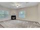 Spacious living room with a fireplace, carpet, and large windows at 121 Cypress Hill Ln, Holly Springs, NC 27540