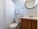 Simple bathroom with a shower, toilet and wooden vanity at 129 Summit Oaks Ln, Holly Springs, NC 27540