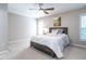 Spacious bedroom with ceiling fan, large window and comfortable bed at 129 Summit Oaks Ln, Holly Springs, NC 27540