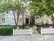 Gray two-story townhome with white picket fence and landscaping at 129 Summit Oaks Ln, Holly Springs, NC 27540