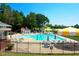 Community swimming pool with lounge chairs and umbrellas at 129 Summit Oaks Ln, Holly Springs, NC 27540