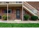 Brick building exterior with entrance, stairs, and landscaping at 130 S Estes Dr # A8, Chapel Hill, NC 27514