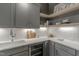 Gray kitchen with white quartz countertops and wine cooler at 1326 Edwards Pond Ct, Apex, NC 27502