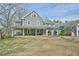 Gray house with a large wrap around porch and backyard at 144G Celebrity Dairy Way, Siler City, NC 27344