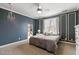 Bedroom with a large bed, built-in shelving, and ceiling fan at 193 N Grande Overlook Dr, Clayton, NC 27527