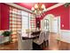 Formal dining room with red walls, chandelier, and hardwood floors at 193 N Grande Overlook Dr, Clayton, NC 27527