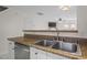 Double stainless steel sink and granite countertops in kitchen at 2248 Ventana Ln, Raleigh, NC 27604