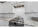 Gas range with granite countertops and white cabinets at 2317 Glade Mill Ct, Fuquay Varina, NC 27526