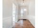 Bright entryway with hardwood floors and white wainscoting at 261 Kissington Way, Benson, NC 27504