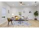 Light-filled living room with hardwood floors, comfy couch, and ceiling fan at 308 Cherry Grove St, Durham, NC 27703