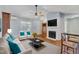 Living room with fireplace, hardwood floors, and large TV at 308 Deep Creek Dr, Clayton, NC 27520