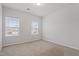 Bright bedroom with neutral carpeting and two windows at 316 Bedivere Ln, Durham, NC 27703