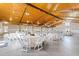 Large event barn interior with white tables and chairs, ready for a wedding or event at 3200 Bliss Trl, Stem, NC 27581