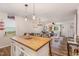 Eat-in kitchen with butcher block island and view of living room at 415 Melbourne St, Durham, NC 27703