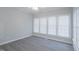 Sunroom features three windows and wood-look flooring at 4701 Regalwood Dr, Raleigh, NC 27613