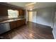 Kitchen with wood cabinets, stainless steel appliances, and dark laminate floors at 5486 B Us Hwy 301, Four Oaks, NC 27524