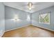 Bedroom with hardwood floors, ceiling fan and window coverings at 6614 Glen Forrest Dr, Chapel Hill, NC 27517