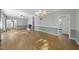 Open dining room with hardwood floors, chandelier and kitchen access at 6614 Glen Forrest Dr, Chapel Hill, NC 27517