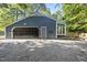 Gray house with a black garage door and gravel driveway at 6614 Glen Forrest Dr, Chapel Hill, NC 27517