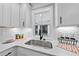 Modern kitchen with white cabinets and a farmhouse sink at 709 Chandler Rd, Durham, NC 27703